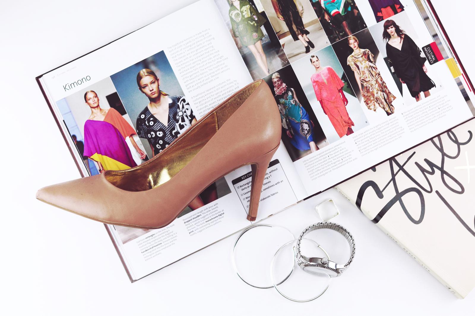 Fashion accessories including stiletto shoe, magazine, and jewellery styled for consultation